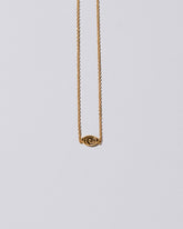 product_hover::Closeup detail of the Gold Altered State Necklace on light color background.