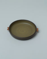 Closeup details of the Emris Dark Stoneware Saucer on light color background.