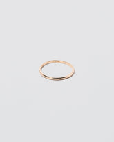 Details view of the Gold 1mm Half Round Band on light color background.