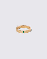 Gold Emerald North South 4mm Baguette-Set Piet Band on light color background.