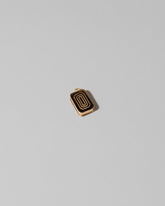 View from the back of the Sardine Can Charm on light color background.