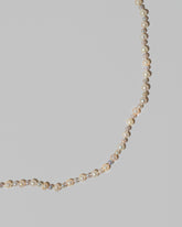 Closeup details of the Ula Pearl Necklace 004 on light color background.
