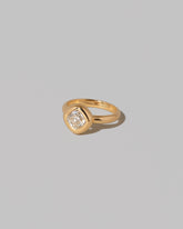 View from the side of a past edition of the Diamond Poise Ring on light color background.