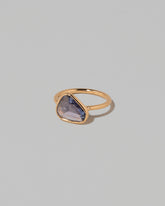 View from the side of the Gusher Purple Sapphire Ring 001 on light color background.