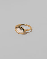 View from the side of the Gusher Teal Sapphire Ring 038 on light color background.