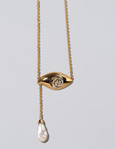 Closeup details of the Pearl State Shifter Necklace on light color background.