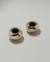 Pearce Objects Cast Bronze Globular Candle Holder Set on light color background.