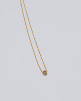 Champagne Diamond Sun & Moon Necklace on light color background.