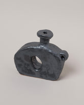 Closeup details of the Willem van Hooff Iridium Tiny Core Vessel on light color background.