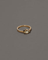 View from the side of the Beholden Ring on grey color background.