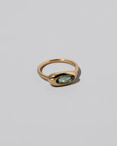 View from the side of the Tourmaline Equalize Ring on light color background.