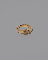 View from the side of the Champagne Diamond Fold Ring on light color background.