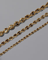 Closeup details of the CRZM Gold Bedrock Mini Bracelet, Gold Bedrock Medium Bracelet, and Gold Bedrock Bracelet on light color background.