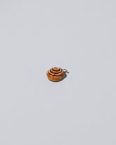 Cinnamon Roll Charm - Enamel on light colored background
