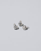 Silver garlic charm on light colored background