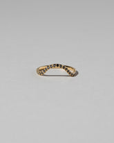 Gold Pavé Black Diamond Curve Band on light color background.