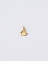 Clams Casino Charm on light color background.