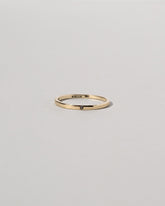 Gold 1.5mm Square Wire Band with Single Stone Black Diamond 1.3mm on light color background.
