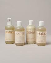 Sisters Body Hand Soap, Gentle Body Wash, Balancing Shampoo and Nourishing Conditioner on light color background.