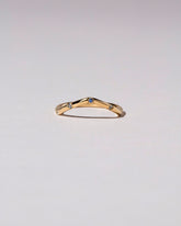 Gold Blue Sapphire Five Stone Low Peak Band on light color background.