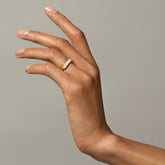 product_details::Gold Pink Opal Five Triangle Ring on model.