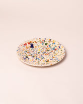Closeup details of the La Ceramica Vincenzo Del Monaco Colored Drops Medium Dish on light color background.