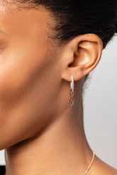 Gold White Diamond Tiny Loop Hoop Earring paired with the Black Diamond Infinity Charm on model.