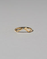Gold Three Stone Blue Sapphire High Peak Band on light color background.