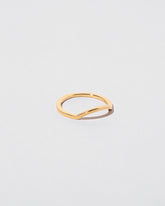 View from the side of the Gold Square Wire Mini Curve Band on light color background.