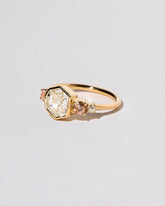 Theia Ring on light color background.