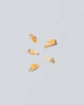 Swiss Cheese Charms on light color background.