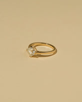 View from the side of the Cushion Modified Brilliant Diamond Solitaire Ring on light color background.