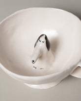 Closeup detail of the Eleonor Boström Dog Cup on light color background.