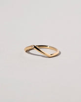 Closeup details of the Gold White Diamond Single Stone Luna Peak Band on light color background.