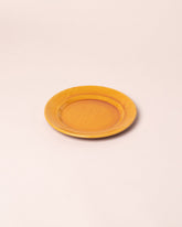 Closeup details of the La Ceramica Vincenzo Del Monaco Caramel Yellow Dessert Dish on light color background.