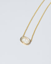 Grace Intaglio Seal Necklace on light color background.