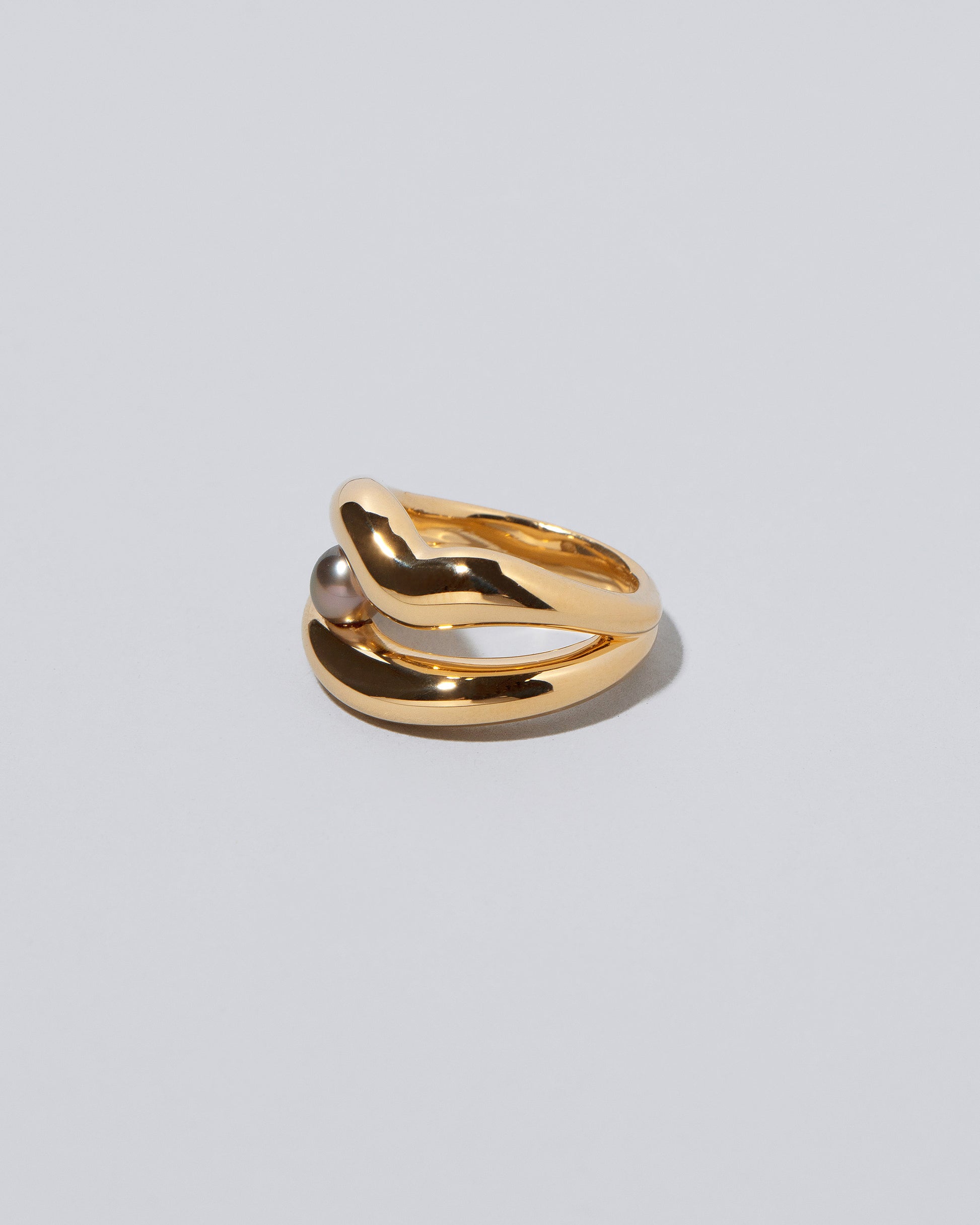 View from the side of the Ocean of Unity Ring on light color background.