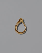 View from the side of the CRZM Gold Boulder Ring on light color background.