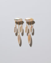 Egret Pearl Earrings on light color background.