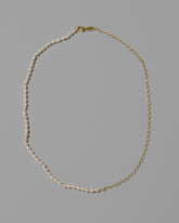 Half Oval Chain & White Seed Pearl Necklace on light color background.
