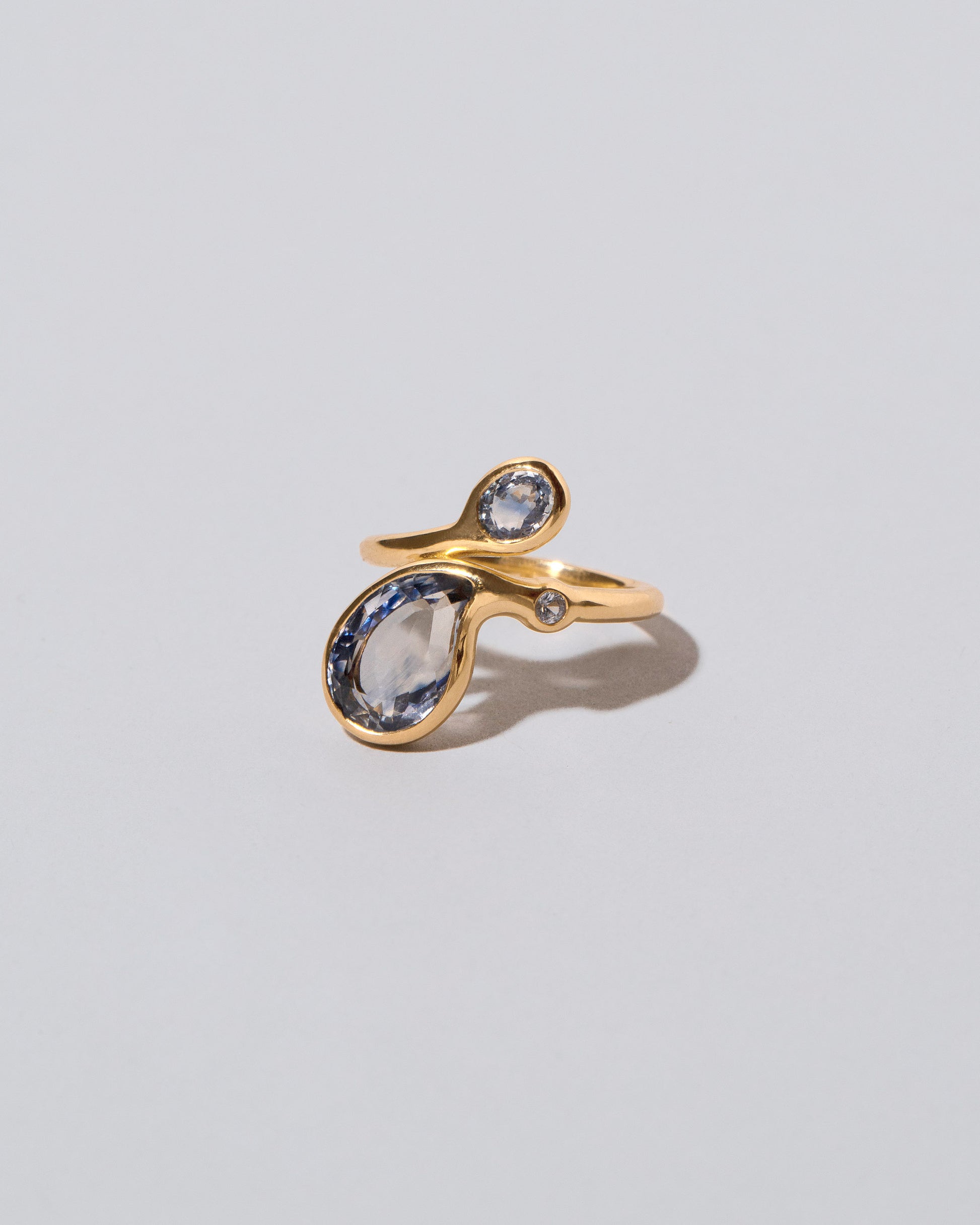 View from the side of the Three Tears Ring on light color background.