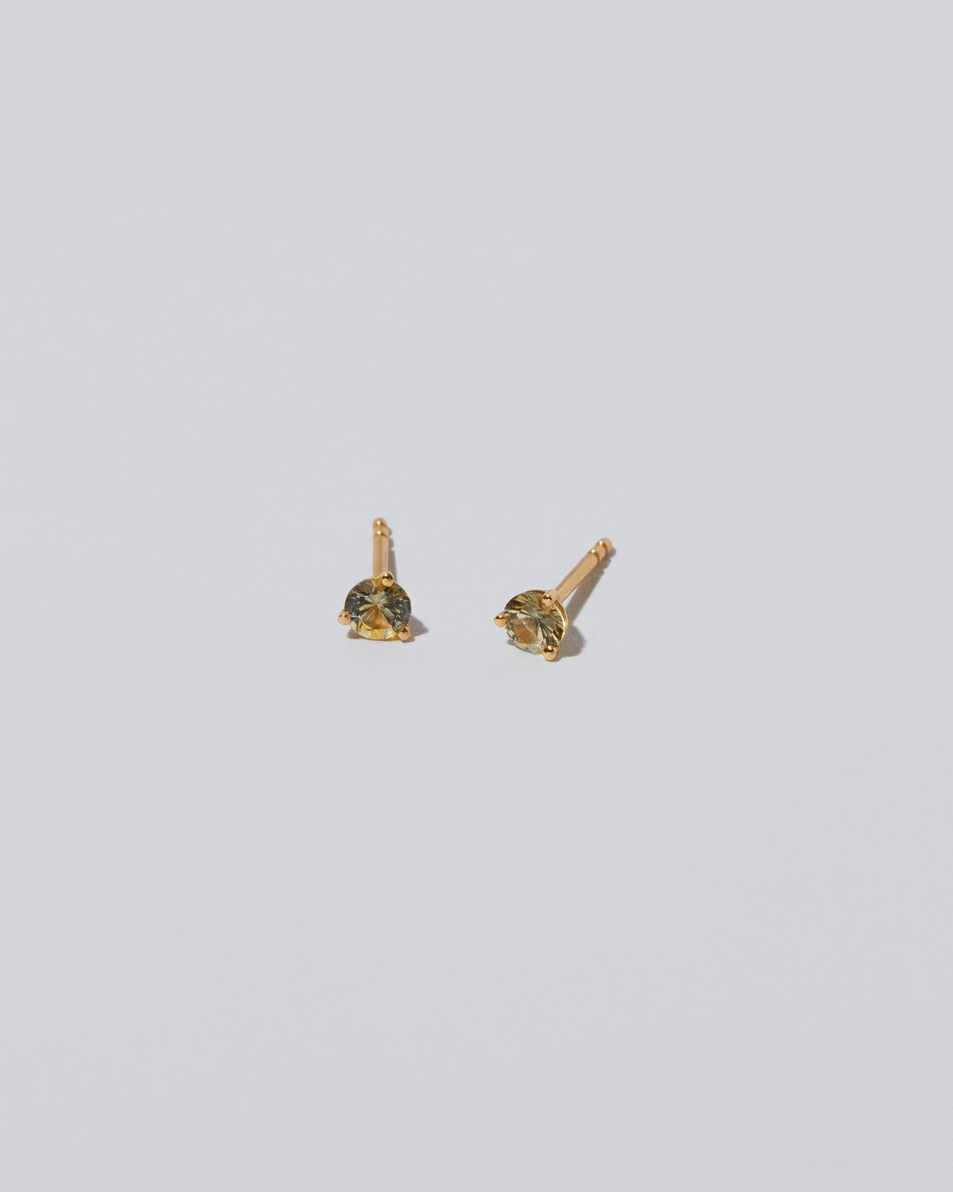 Martini Stud - Yellow/Blue Sapphire on light color background.