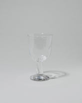 Silje Lindrup Twisted Liqueur Glass on light color background.