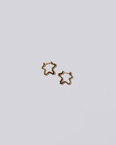 Snow Flower Huggie Hoops on light color background.