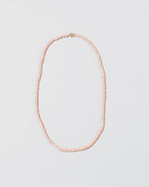 Pink Peony Pebble Seed Pearl Choker Necklace on light color background.