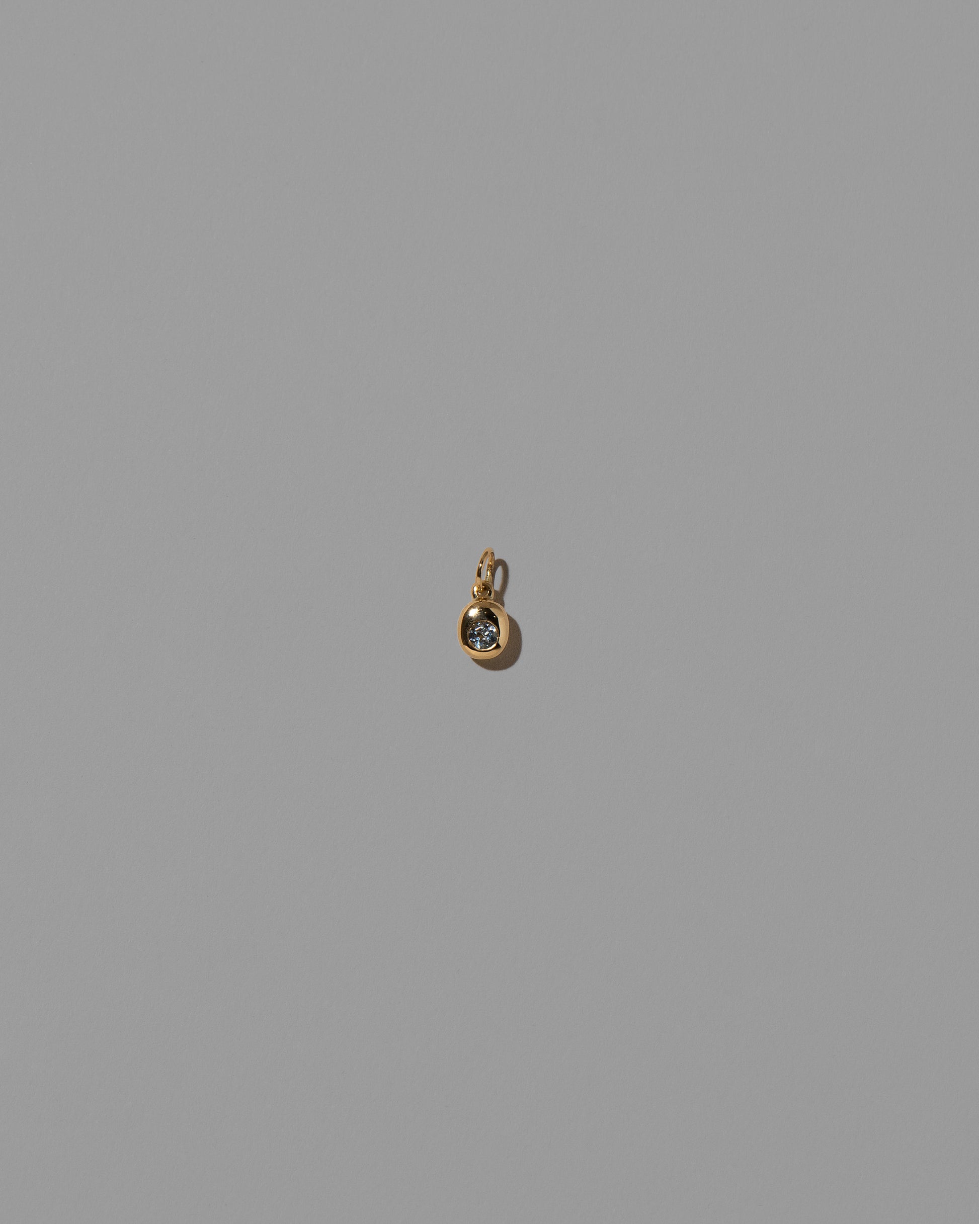 Aquamarine Birthstone Level Charm on light color background.