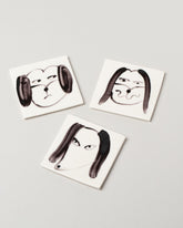 Eleonor Boström Dog Face Coasters on light color background.