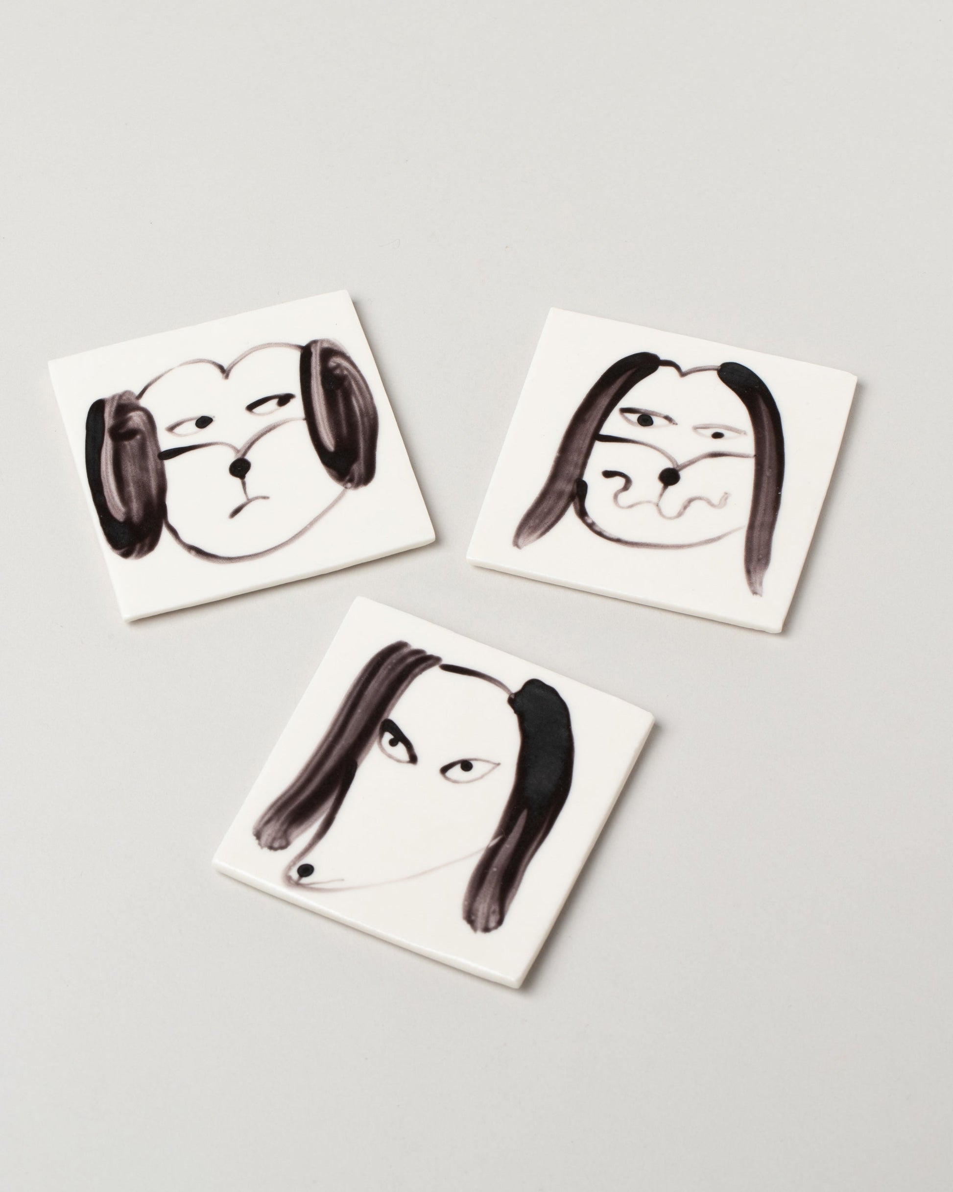 Eleonor Boström Dog Face Coasters on light color background.