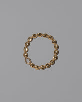 CRZM Gold Mini Bedrock Bracelet on light color background.