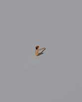 Foot Stud Earring Single on light color background.